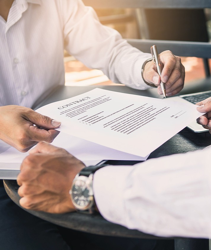 men signing legal contract