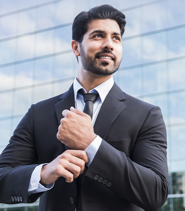 a businessman adjusts his sleeves