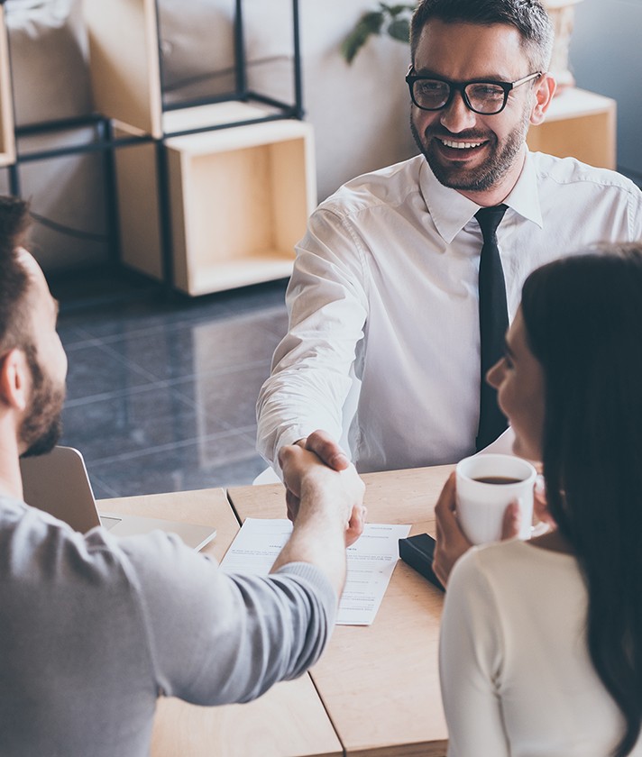 a meeting between businesspeople where the men shake hands